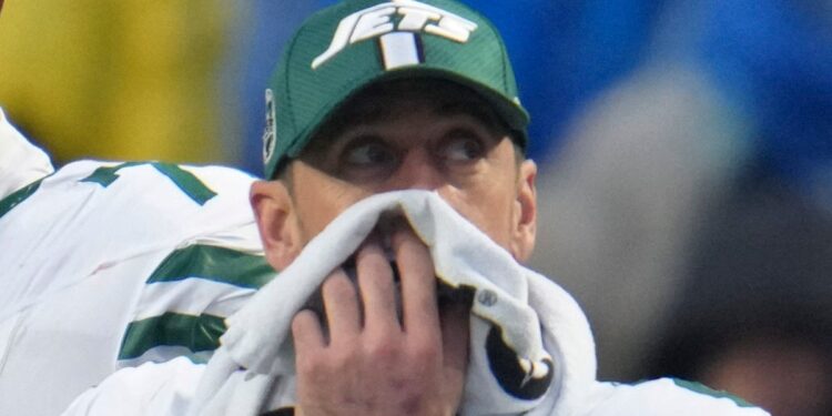 Aaron Rodgers covers his face