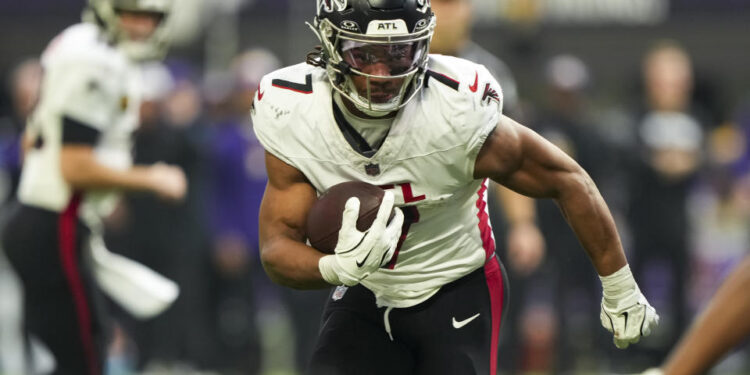 MINNEAPOLIS, MINNESOTA - DECEMBER 8: Running back Bijan Robinson #7 of the Atlanta Falcons carries the ball during the first half of an NFL football game against the Minnesota Vikings, at U.S. Bank Stadium on December 8, 2024 in Minneapolis, Minnesota. (Photo by Todd Rosenberg/Getty Images)