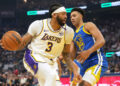 Dec 25, 2024; San Francisco, California, USA; Los Angeles Lakers forward Anthony Davis (3) dribbles against Golden State Warriors forward Trayce Jackson-Davis (32) during the first quarter at Chase Center. Mandatory Credit: Darren Yamashita-Imagn Images