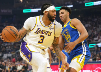 Dec 25, 2024; San Francisco, California, USA; Los Angeles Lakers forward Anthony Davis (3) dribbles against Golden State Warriors forward Trayce Jackson-Davis (32) during the first quarter at Chase Center. Mandatory Credit: Darren Yamashita-Imagn Images