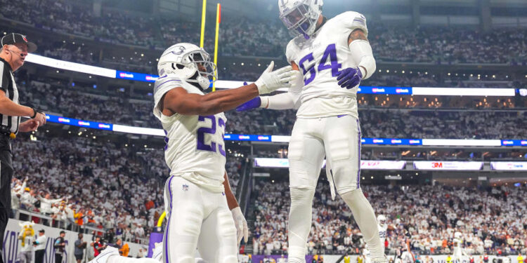 Dec 16, 2024; Minneapolis, Minnesota, USA; Minnesota Vikings cornerback Fabian Moreau (23) and linebacker Kamu Grugier-Hill (54) celebrate a play against the Chicago Bears in the fourth quarter at U.S. Bank Stadium. Mandatory Credit: Brad Rempel-Imagn Images