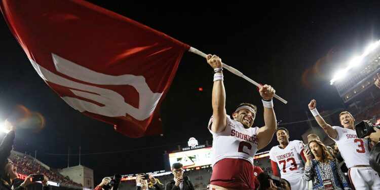 Baker Mayfield waves the OU flag