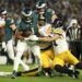 Philadelphia Eagles quarterback Jalen Hurts (1) is tackled by Pittsburgh Steelers linebacker Alex Highsmith (56) and Pittsburgh Steelers linebacker T.J. Watt, right, during the first half of an NFL football game Sunday, Dec. 15, 2024, in Philadelphia. (AP Photo/Matt Slocum)