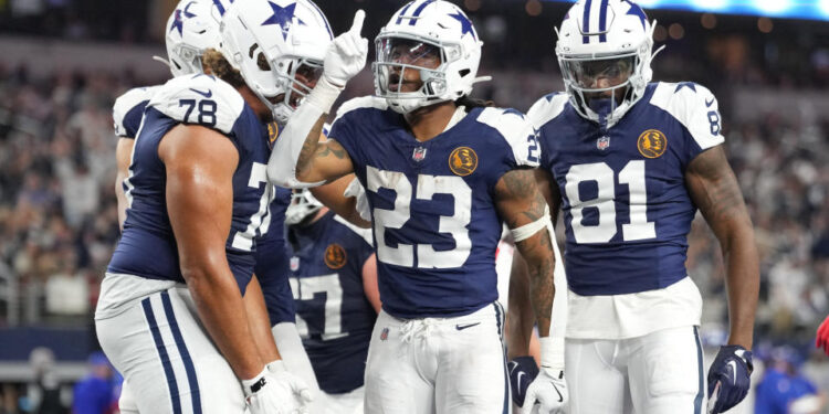 Nov 28, 2024; Arlington, Texas, USA;  Dallas Cowboys running back Rico Dowdle (23) celebrates with teammates after scoring a touchdown against the New York Giants during the second half at AT&T Stadium. Mandatory Credit: Chris Jones-Imagn Images