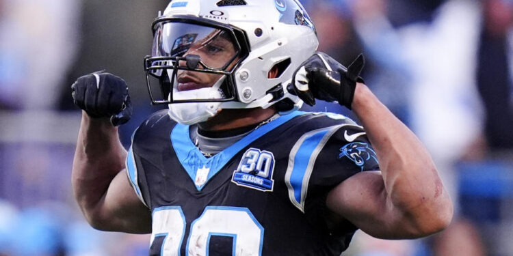 Carolina Panthers running back Chuba Hubbard celebrates after a long run against the Arizona Cardinals during overtime of an NFL football game, Sunday, Dec. 22, 2024, in Charlotte, N.C. (AP Photo/Rusty Jones)