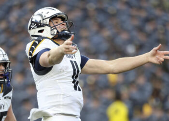 Navy quarterback Blake Horvath (11) celebrates after scoring a touchdown during the first half of an NCAA college football game against Army, Saturday, Dec. 14, 2024, in Landover, Md. (AP Photo/Daniel Kucin Jr.)