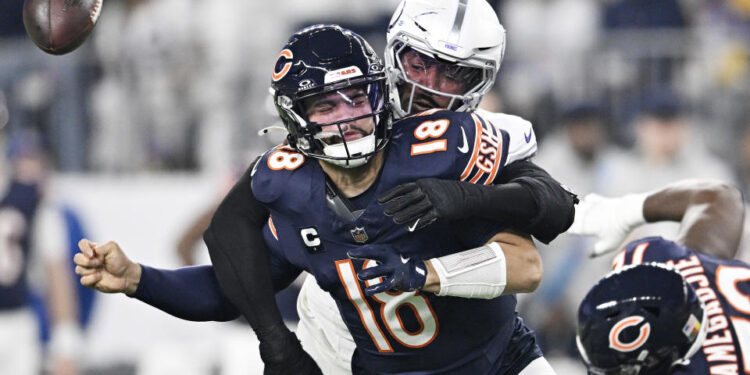 Jonathan Greenard of the Minnesota Vikings strips sacks Caleb Williams of the Chicago Bears during the Vikings' win on Monday night. (Photo by Stephen Maturen/Getty Images)