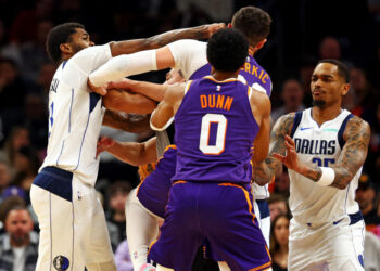 Dec 27, 2024; Phoenix, Arizona, USA; Dallas Mavericks forward Naji Marshall (13) punches Phoenix Suns center Jusuf Nurkic (20) during the third quarter at Footprint Center. Mandatory Credit: Mark J. Rebilas-Imagn Images