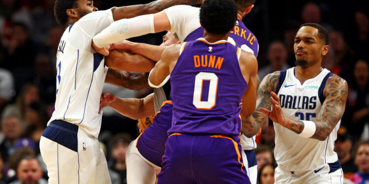 Dec 27, 2024; Phoenix, Arizona, USA; Dallas Mavericks forward Naji Marshall (13) punches Phoenix Suns center Jusuf Nurkic (20) during the third quarter at Footprint Center. Mandatory Credit: Mark J. Rebilas-Imagn Images