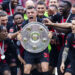 LEVERKUSEN, GERMANY - MAY 18: Granit Xhaka of Leverkusen celebrates the winning of championship trophy with Jeremie Frimpong of Leverkusen (L), Florian Wirtz of Leverkusen (3.L), Victor Boniface of Leverkusen (3.L) and Alejandro Grimaldo of Leverkusen at the winning ceremony after the Bundesliga match between Bayer 04 Leverkusen and FC Augsburg at BayArena on May 18, 2024 in Leverkusen, Germany.(Photo by Mika Volkmann/Getty Images)