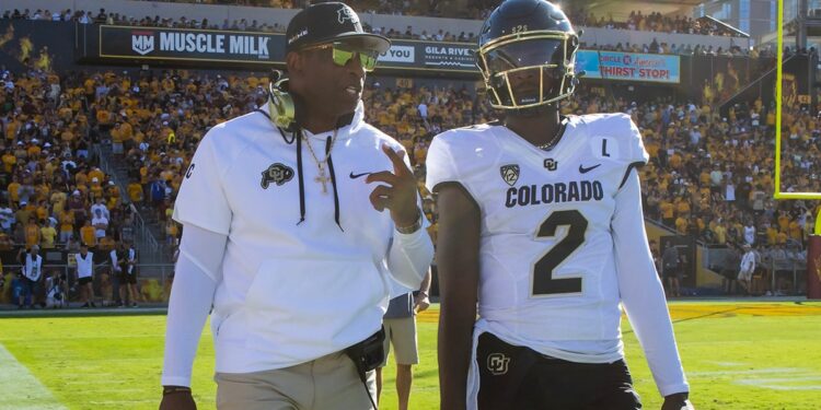 Deion Sanders walks with Shedeur Sanders