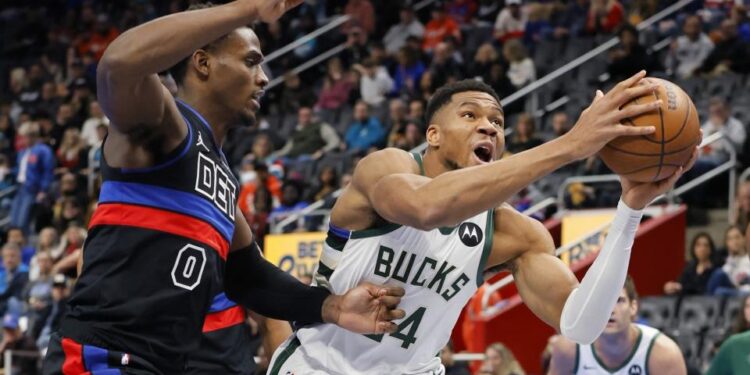 Milwaukee Bucks forward Giannis Antetokounmpo (34) goes to the basket past Detroit Pistons center Jalen Duren (0) during the first half of an Emirates NBA Cup basketball game Tuesday, Dec. 3, 2024, in Detroit. (AP Photo/Duane Burleson)