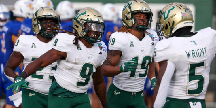 HONOLULU, HAWAII - DECEMBER 24: Ta'Ron Keith #9 of the South Florida Bulls celebrates with Nay'Quan Wright #5 after scoring a touchdown during the first half of the game against the San Jose Spartans at the Clarence T.C. Ching Athletics Complex on December 24, 2024 in Honolulu, Hawaii. (Photo by Darryl Oumi/Getty Image