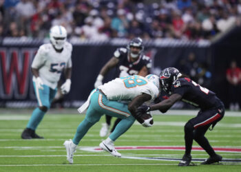 Miami Dolphins wide receiver Grant DuBose (88) is brought down by Houston Texans safety Calen Bullock, right, on a play that left DuBose injured, during the second half of an NFL football game Sunday, Dec. 15, 2024, in Houston. (AP Photo/Eric Christian Smith)