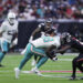 Miami Dolphins wide receiver Grant DuBose (88) is brought down by Houston Texans safety Calen Bullock, right, on a play that left DuBose injured, during the second half of an NFL football game Sunday, Dec. 15, 2024, in Houston. (AP Photo/Eric Christian Smith)