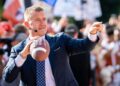 Analyst Kirk Herbstreit tosses the football with fans on the set of ESPN's College Game Day at the University of Texas ahead of the Longhorns' game against the Georgia Bulldogs in Austin, Texas, on Oct. 19, 2024.