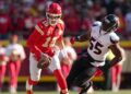 Patrick Mahomes runs past a player