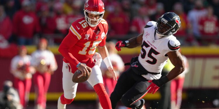 Patrick Mahomes runs past a player