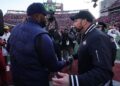 Sherrone Moore shakes hands with Ryan Day