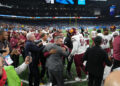 DETROIT, MICHIGAN - JANUARY 18: Washington Commanders players and coaches celebrate after defeating the Detroit Lions 45-31 in the NFC Divisional Playoff at Ford Field on January 18, 2025 in Detroit, Michigan.  (Photo by Nic Antaya/Getty Images)