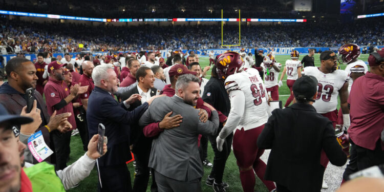 DETROIT, MICHIGAN - JANUARY 18: Washington Commanders players and coaches celebrate after defeating the Detroit Lions 45-31 in the NFC Divisional Playoff at Ford Field on January 18, 2025 in Detroit, Michigan.  (Photo by Nic Antaya/Getty Images)