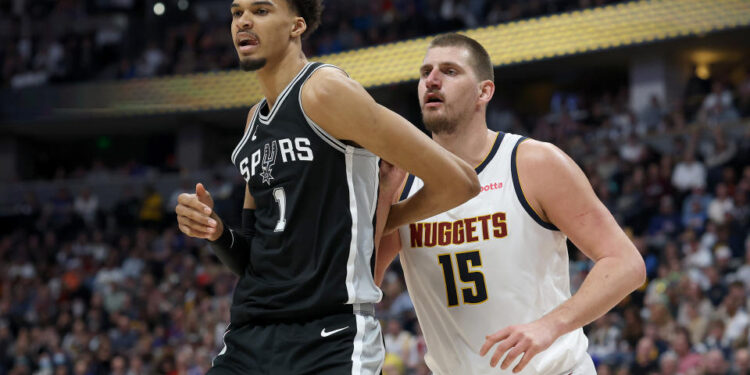 DENVER, COLORADO - JANUARY 03: Victor Wembanyama #1 of the San Antonio Spurs is guarded by Nikola Jokic #15 of the Denver Nuggets in the fourth quarter at Ball Arena on January 03, 2025 in Denver, Colorado. NOTE TO USER: User expressly acknowledges and agrees that, by downloading and or using this photograph, User is consenting to the terms and conditions of the Getty Images License Agreement.  (Photo by Matthew Stockman/Getty Images)