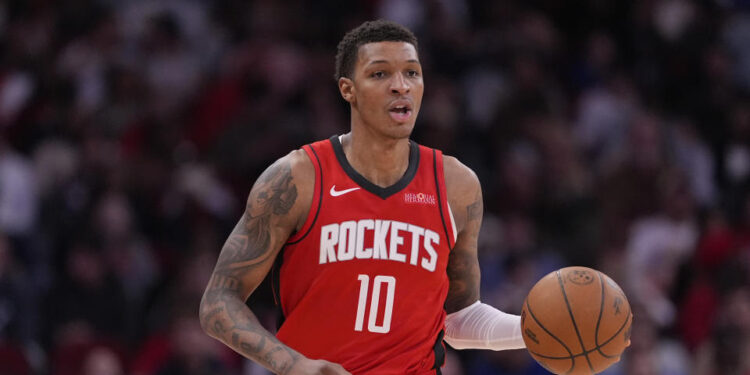 Houston Rockets' Jabari Smith Jr. (10) brings the ball up the court against the Dallas Mavericks during the second half of an NBA basketball game Wednesday, Jan. 1, 2025, in Houston. The Rockets won 110-99. (AP Photo/David J. Phillip)