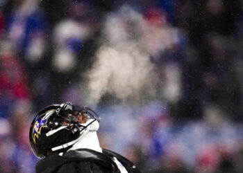 Baltimore Ravens quarterback Lamar Jackson (8) warms up before playing against the Buffalo Bills in an NFL divisional playoff football game, Sunday, Jan. 19, 2025, in Orchard Park, N.Y. (AP Photo/Gene J. Puskar)