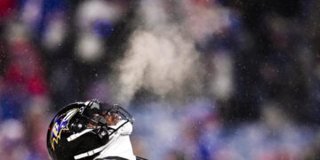 Baltimore Ravens quarterback Lamar Jackson (8) warms up before playing against the Buffalo Bills in an NFL divisional playoff football game, Sunday, Jan. 19, 2025, in Orchard Park, N.Y. (AP Photo/Gene J. Puskar)