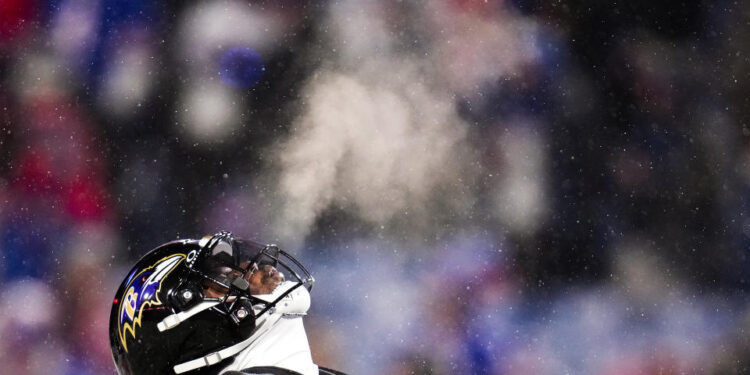 Baltimore Ravens quarterback Lamar Jackson (8) warms up before playing against the Buffalo Bills in an NFL divisional playoff football game, Sunday, Jan. 19, 2025, in Orchard Park, N.Y. (AP Photo/Gene J. Puskar)