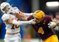 Jan 1, 2025; Atlanta, GA, USA; Arizona State Sun Devils running back Cam Skattebo (4) and Texas Longhorns defensive back Michael Taaffe (16) push each other during the second half of the Peach Bowl at Mercedes-Benz Stadium. Mandatory Credit: Dale Zanine-Imagn Images