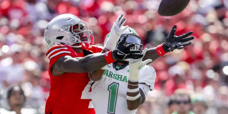 Sep 21, 2024; Columbus, Ohio, USA; Ohio State Buckeyes wide receiver Jeremiah Smith (4) goes for the ball with Marshall Thundering Herd defensive back Josh Moten (1) during the first quarter at Ohio Stadium. Mandatory Credit: Joseph Maiorana-Imagn Images