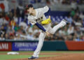 Mar 20, 2023; Miami, Florida, USA; Japan starting pitcher Roki Sasaki (14) delivers a pitch during the first inning against Mexico at LoanDepot Park. Mandatory Credit: Sam Navarro-Imagn Images