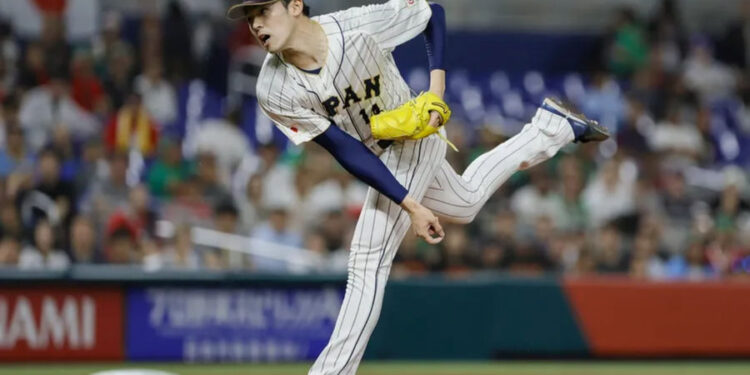 Mar 20, 2023; Miami, Florida, USA; Japan starting pitcher Roki Sasaki (14) delivers a pitch during the first inning against Mexico at LoanDepot Park. Mandatory Credit: Sam Navarro-Imagn Images