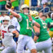 Sep 28, 2024; South Bend, Indiana, USA; Notre Dame Fighting Irish quarterback Riley Leonard (13) throws a pass for a touchdown against the Louisville Cardinals in the first quarter at Notre Dame Stadium. Mandatory Credit: Matt Cashore-Imagn Images