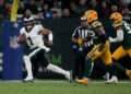 Sep 6, 2024; Sao Paulo, BRA; Philadelphia Eagles quarterback Jalen Hurts (1) scrambles against Green Bay Packers defensive end Rashan Gary (52) during the first half at Neo Quimica Arena. Mandatory Credit: Kirby Lee-Imagn Images