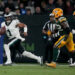 Sep 6, 2024; Sao Paulo, BRA; Philadelphia Eagles quarterback Jalen Hurts (1) scrambles against Green Bay Packers defensive end Rashan Gary (52) during the first half at Neo Quimica Arena. Mandatory Credit: Kirby Lee-Imagn Images