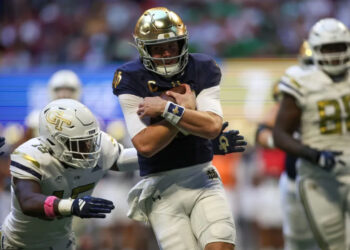 Oct 19, 2024; Atlanta, Georgia, USA; Notre Dame Fighting Irish quarterback Riley Leonard (13) runs the ball for a touchdown against the Georgia Tech Yellow Jackets in the second quarter at Mercedes-Benz Stadium. Mandatory Credit: Brett Davis-Imagn Images