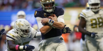 Oct 19, 2024; Atlanta, Georgia, USA; Notre Dame Fighting Irish quarterback Riley Leonard (13) runs the ball for a touchdown against the Georgia Tech Yellow Jackets in the second quarter at Mercedes-Benz Stadium. Mandatory Credit: Brett Davis-Imagn Images