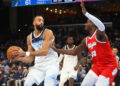 Jan 20, 2025; Memphis, Tennessee, USA; Minnesota Timberwolves center Rudy Gobert (27) drives to the basket as Memphis Grizzlies forward Jaren Jackson Jr. (13) defends during the second half at FedExForum. Mandatory Credit: Petre Thomas-Imagn Images