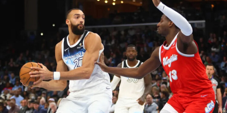 Jan 20, 2025; Memphis, Tennessee, USA; Minnesota Timberwolves center Rudy Gobert (27) drives to the basket as Memphis Grizzlies forward Jaren Jackson Jr. (13) defends during the second half at FedExForum. Mandatory Credit: Petre Thomas-Imagn Images