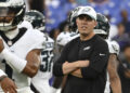 Aug 9, 2024; Baltimore, Maryland, USA; Philadelphia Eagles offensive coordinator Kellen Moore looks on as quarterback Jalen Hurts (1) throws before a preseason game against the Baltimore Ravens at M&amp;T Bank Stadium. Mandatory Credit: Tommy Gilligan-Imagn Images