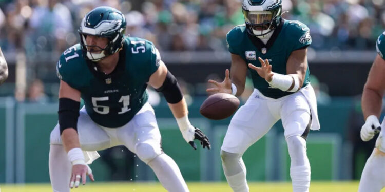 Oct 13, 2024; Philadelphia, Pennsylvania, USA; Philadelphia Eagles center Cam Jurgens (51) snaps the ball to quarterback Jalen Hurts (1) in a game against the Cleveland Browns at Lincoln Financial Field. Mandatory Credit: Bill Streicher-Imagn Images