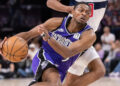 Jan 19, 2025; Sacramento, California, USA; Sacramento Kings guard De'Aaron Fox (5) drives to the basket against the Washington Wizards during the fourth quarter at Golden 1 Center. Mandatory Credit: Ed Szczepanski-Imagn Images