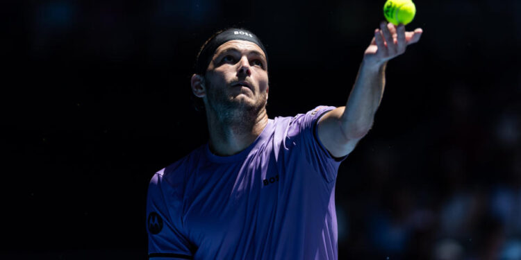 Jan 14, 2025; Melbourne, Victoria, Australia; Taylor Fritz of United States of America serves during his match against Jenson Brooksby of United States of America in the first round of the men's singles at the 2025 Australian Open at Melbourne Park. Mandatory Credit: Mike Frey-Imagn Images