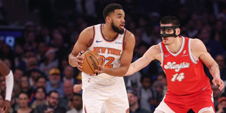 Jan 27, 2025; New York, New York, USA; New York Knicks center Karl-Anthony Towns (32) is guarded by Memphis Grizzlies center Zach Edey (14) during the first half at Madison Square Garden. Mandatory Credit: Vincent Carchietta-Imagn Images