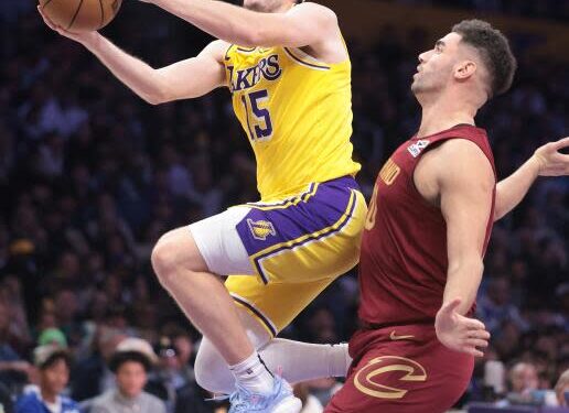 Laker Austin Reaves drives past Cavalier Georgres Niang at Crypto.com Arena on Tuesday.