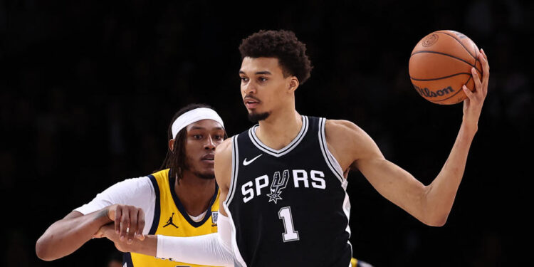 San Antonio Spurs' French forward-center #01 Victor Wembanyama (R) holds the ball as Indiana Pacers' US center #33 Myles Turner (L) defends during the NBA basketball game between the San Antonio Spurs and the Indiana Pacers at the Accor Arena - Palais Omnisports de Paris-Bercy - in Paris on January 25, 2025. (Photo by FRANCK FIFE / AFP) (Photo by FRANCK FIFE/AFP via Getty Images)