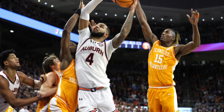 Jan 25, 2025; Auburn, Alabama, USA;  Auburn Tigers forward Johni Broome (4) shoots the ball against Tennessee Volunteers guard Jahmai Mashack (15) during the second half at Neville Arena. Mandatory Credit: John Reed-Imagn Images