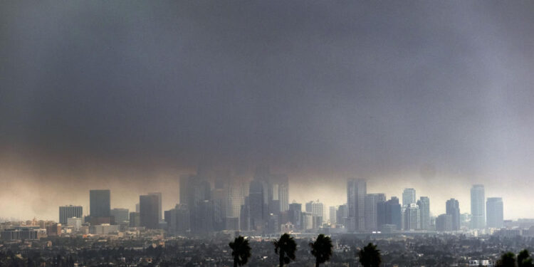 Thick heavy smoke from wildfires shrouds downtown Los Angeles on Wednesday, Jan. 8, 2025. (AP Photo/Richard Vogel)